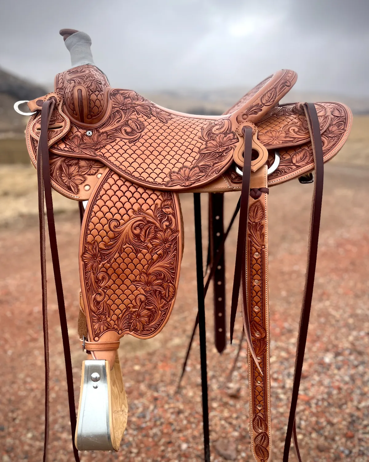 Basket-stamped working saddle photographed outdoors