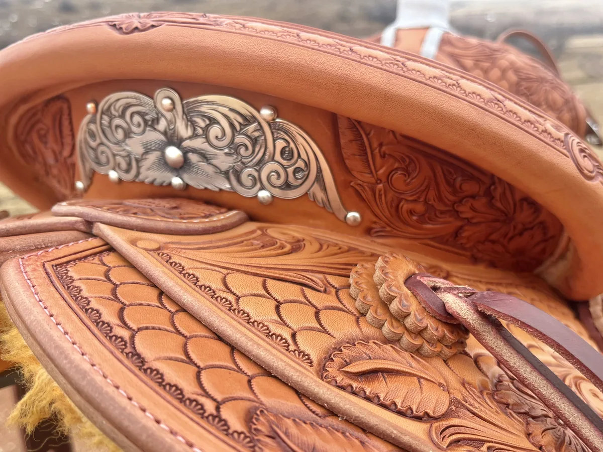 Silver-mounted cantle with hand-carved Sheridan-style floral tooling