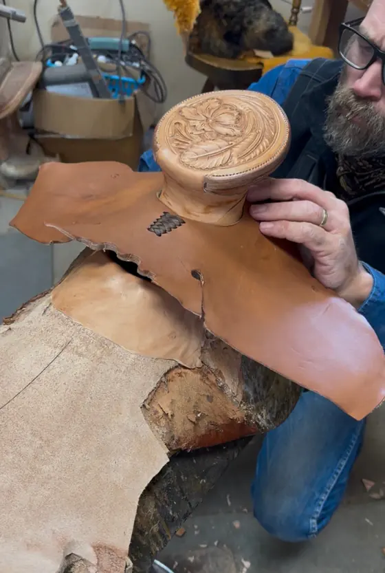 Paul Van Dyke fitting a hand-carved horn cap while building a saddle
