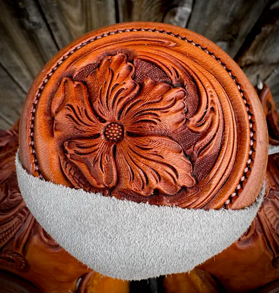 Saddle horn cap carved with a single large flower and hand-stitched edge